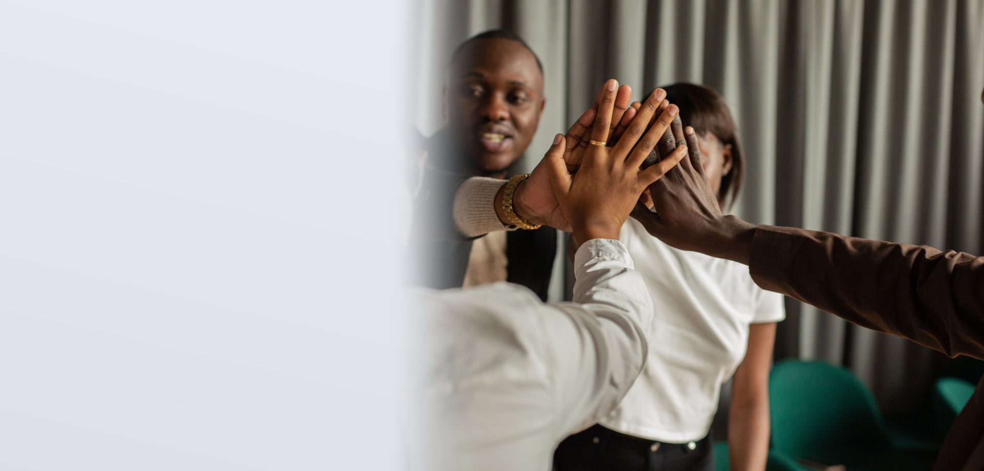 Corporate team hands-in huddle during facilitated team development session