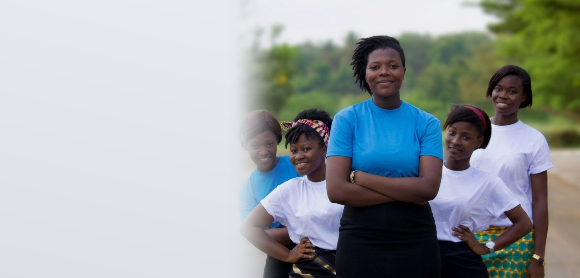Corporate team members in clean blue and white shirts smiling together